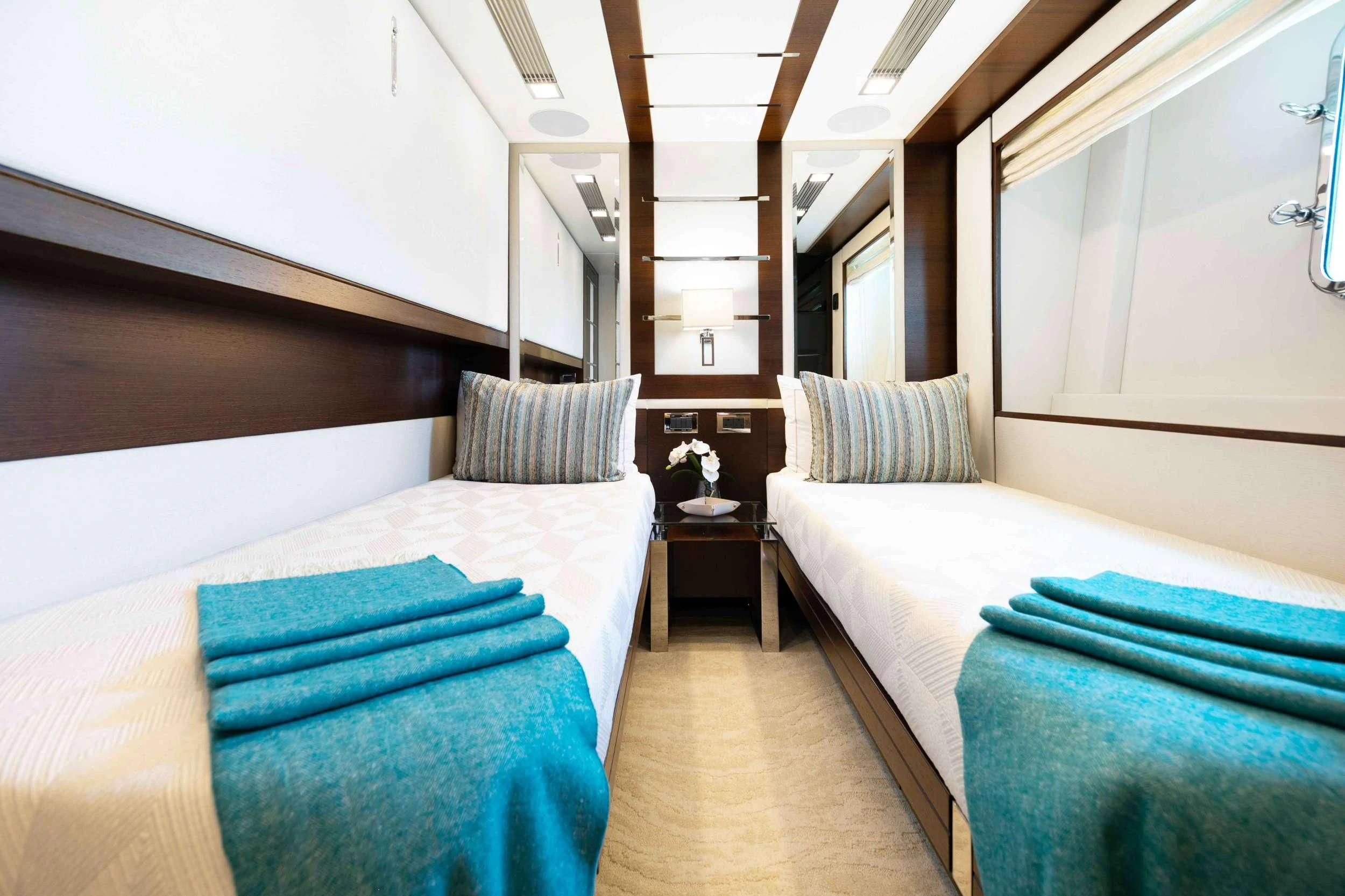 a room with two beds aboard INSIEME Yacht for Sale