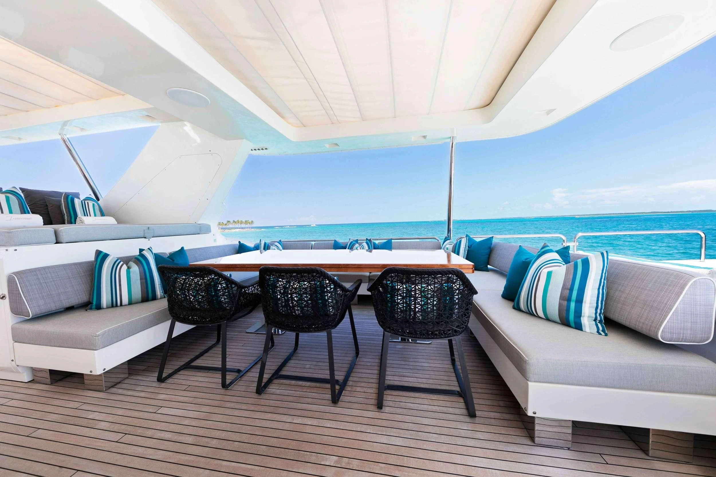 a room with a couch and a table and chairs aboard INSIEME Yacht for Sale