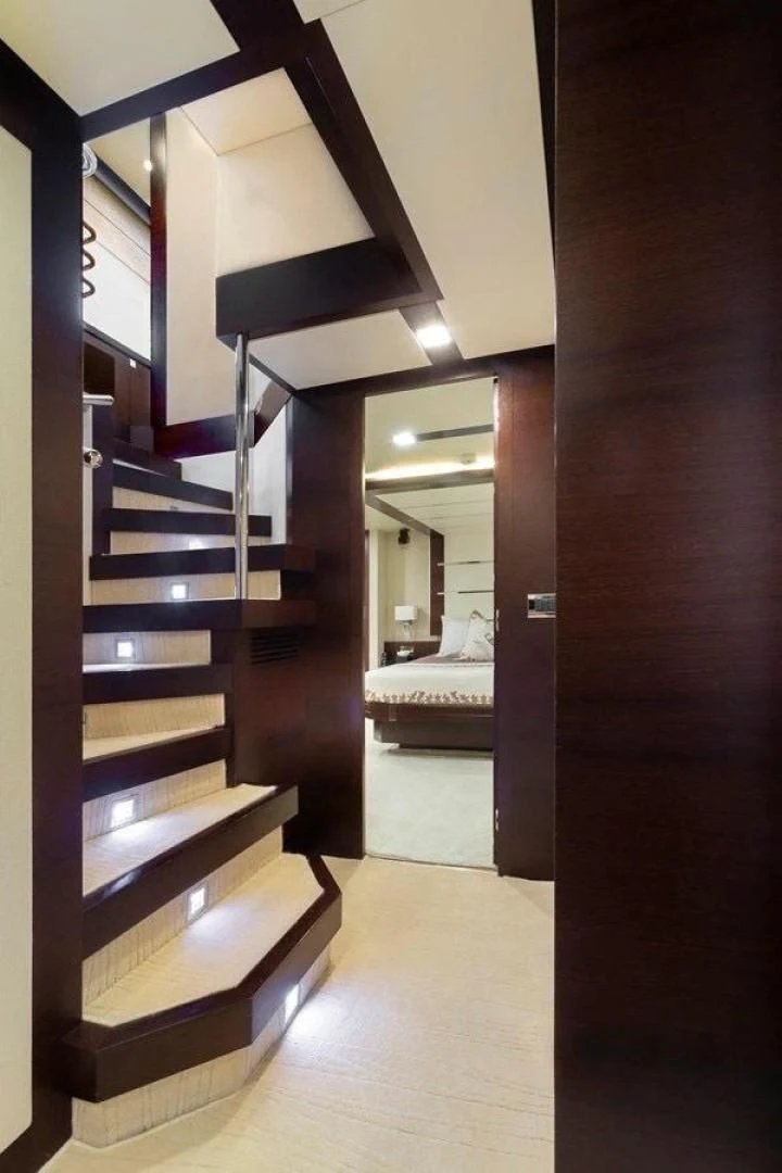 a wooden staircase with a bed aboard INSIEME Yacht for Sale