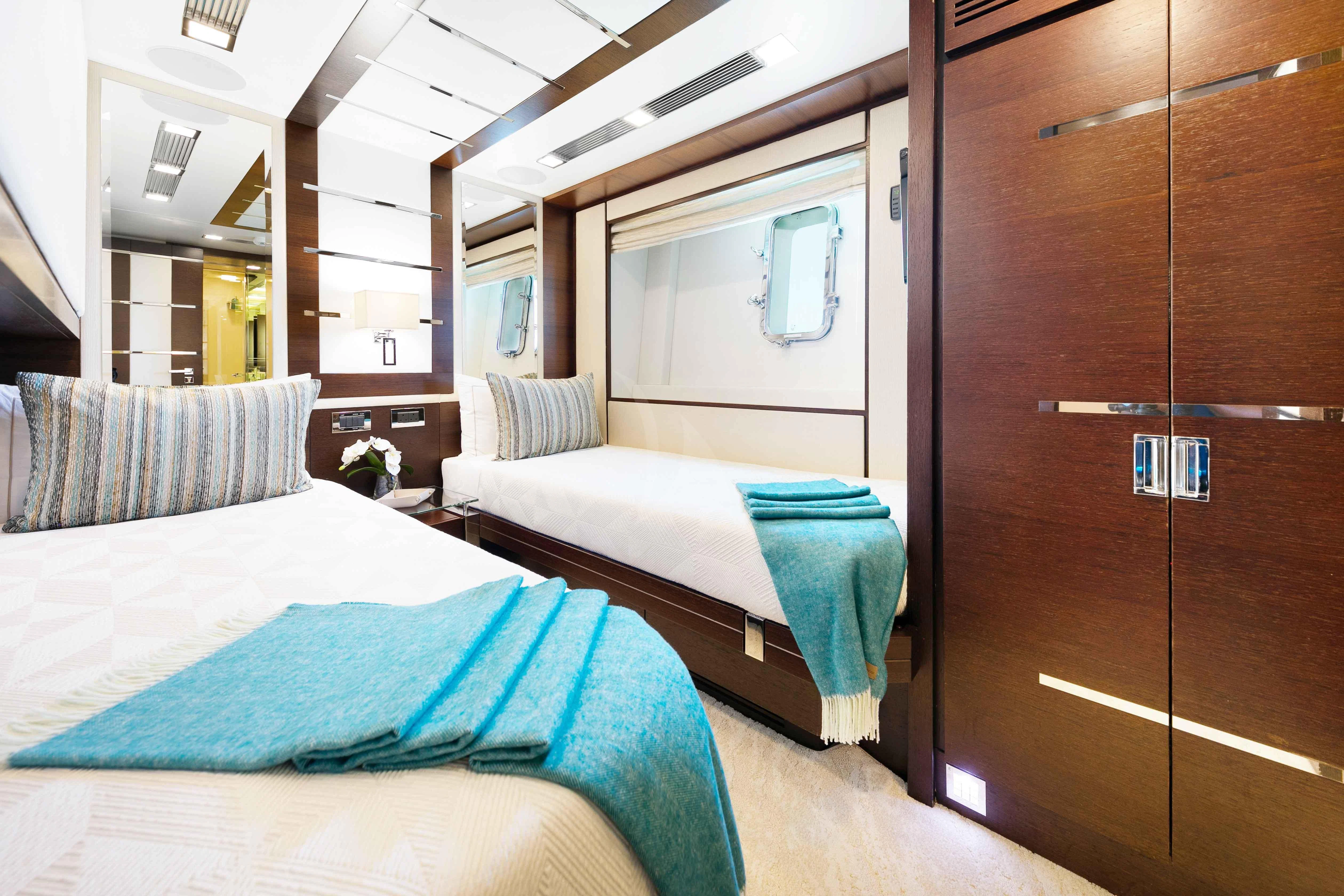 a bedroom with a bed and a closet aboard INSIEME Yacht for Sale