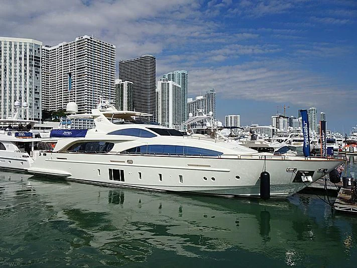 a white yacht in a harbor aboard INSIEME Yacht for Sale