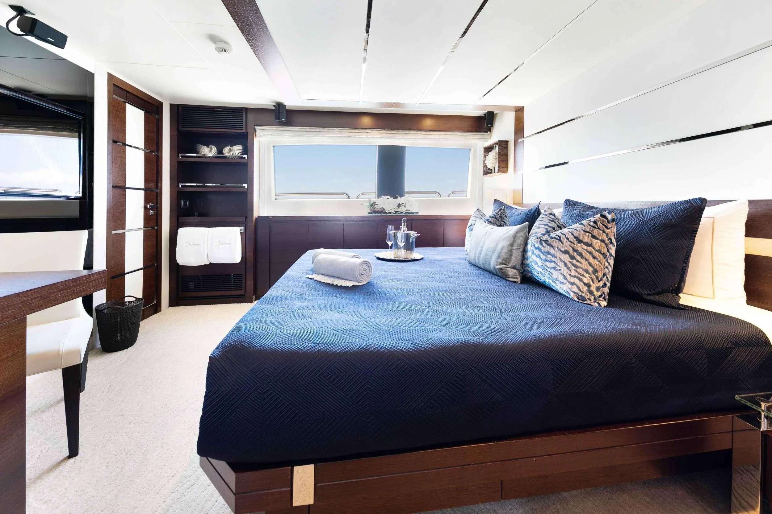 a bed with a blue comforter aboard INSIEME Yacht for Sale