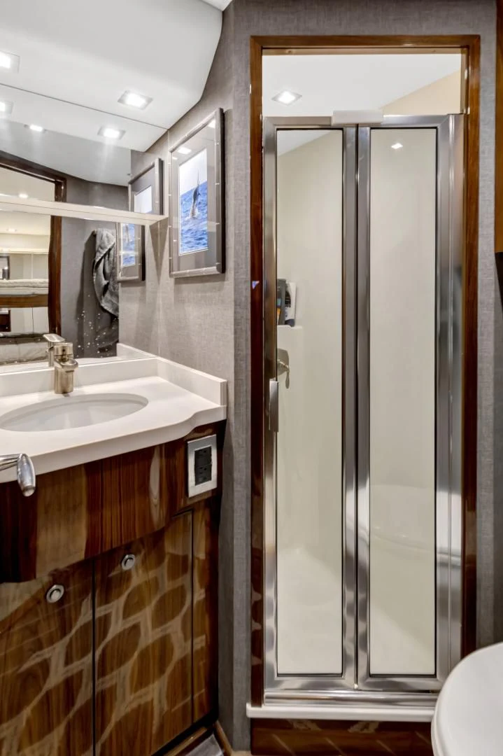 a bathroom with a glass shower door aboard POZO SECO Yacht for Sale