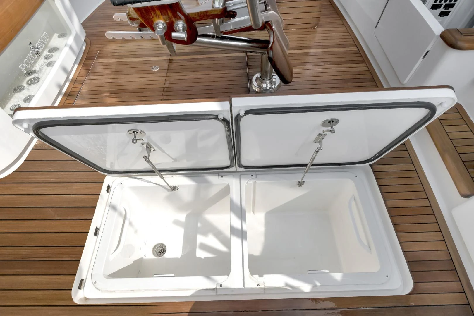 a white rectangular object with a black handle on a wooden surface aboard POZO SECO Yacht for Sale