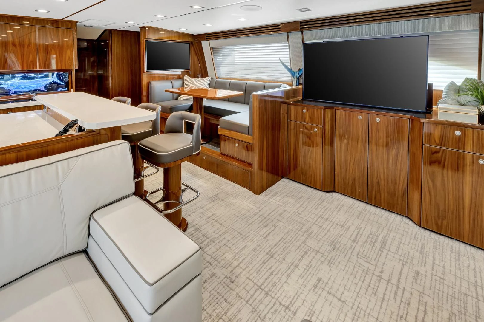 a room with a tv and a table and chairs aboard POZO SECO Yacht for Sale
