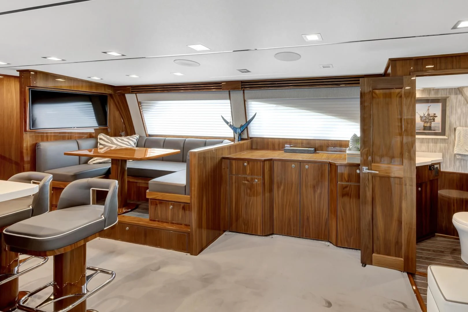 a room with a wood table and chairs and a wood cabinet aboard POZO SECO Yacht for Sale