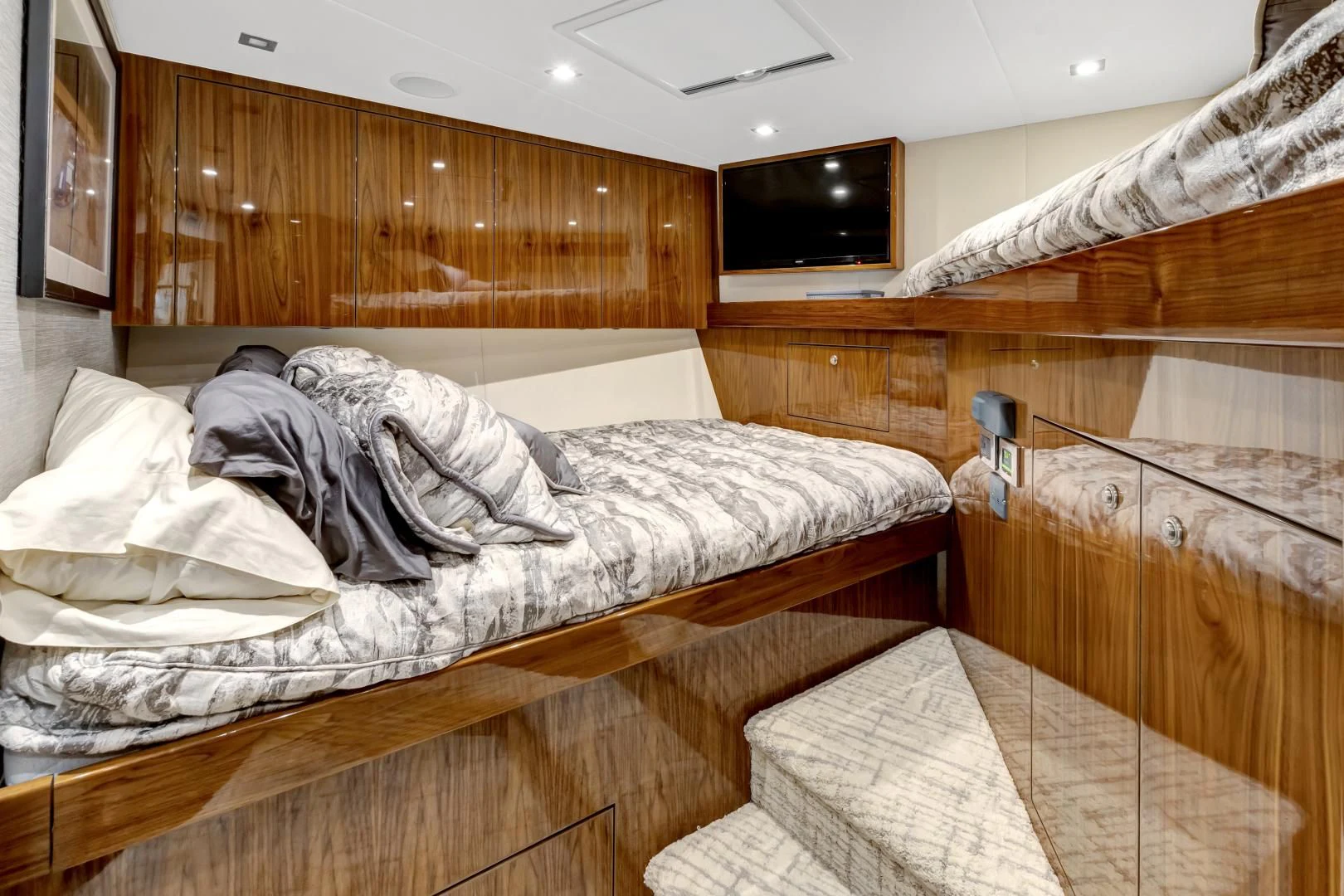a bed with a wooden headboard aboard POZO SECO Yacht for Sale