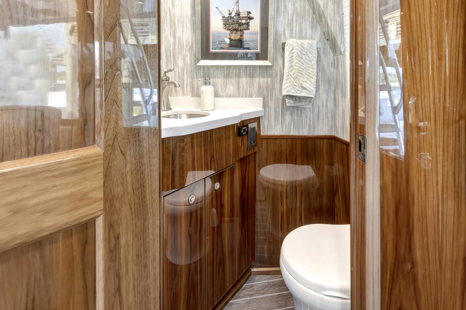 a bathroom with a toilet sink and a mirror aboard POZO SECO Yacht for Sale