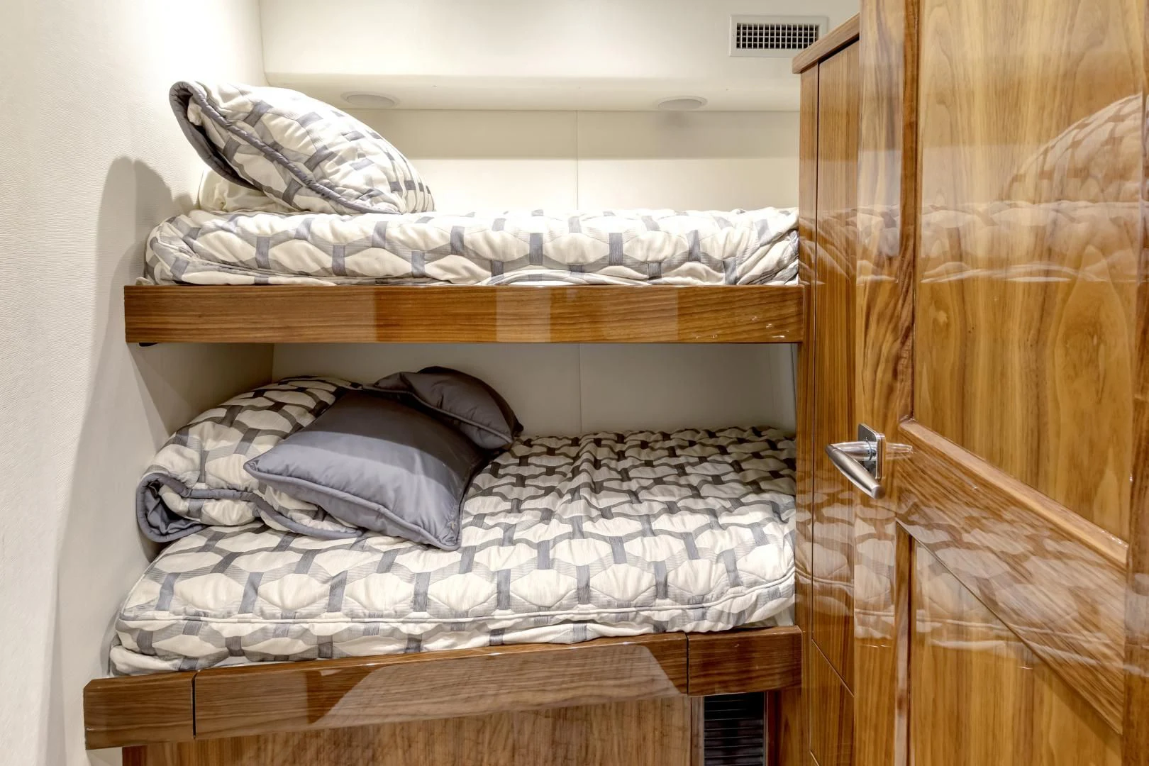 a bed with a wooden frame aboard POZO SECO Yacht for Sale