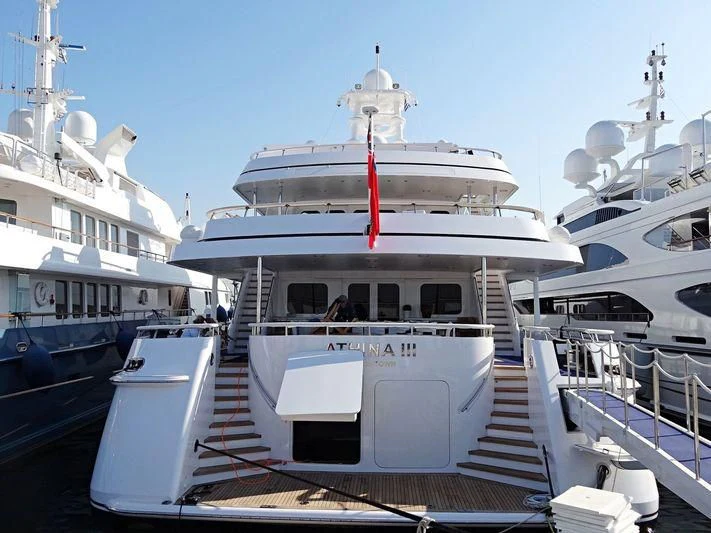 a large white boat in a harbor aboard ATHINA III Yacht for Sale