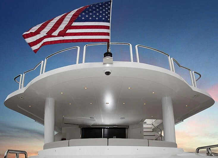 a large military ship with a flag on top aboard PINGUINITO Yacht for Sale
