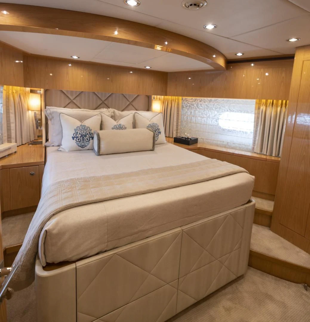 a bed with a white comforter aboard PINGUINITO Yacht for Sale