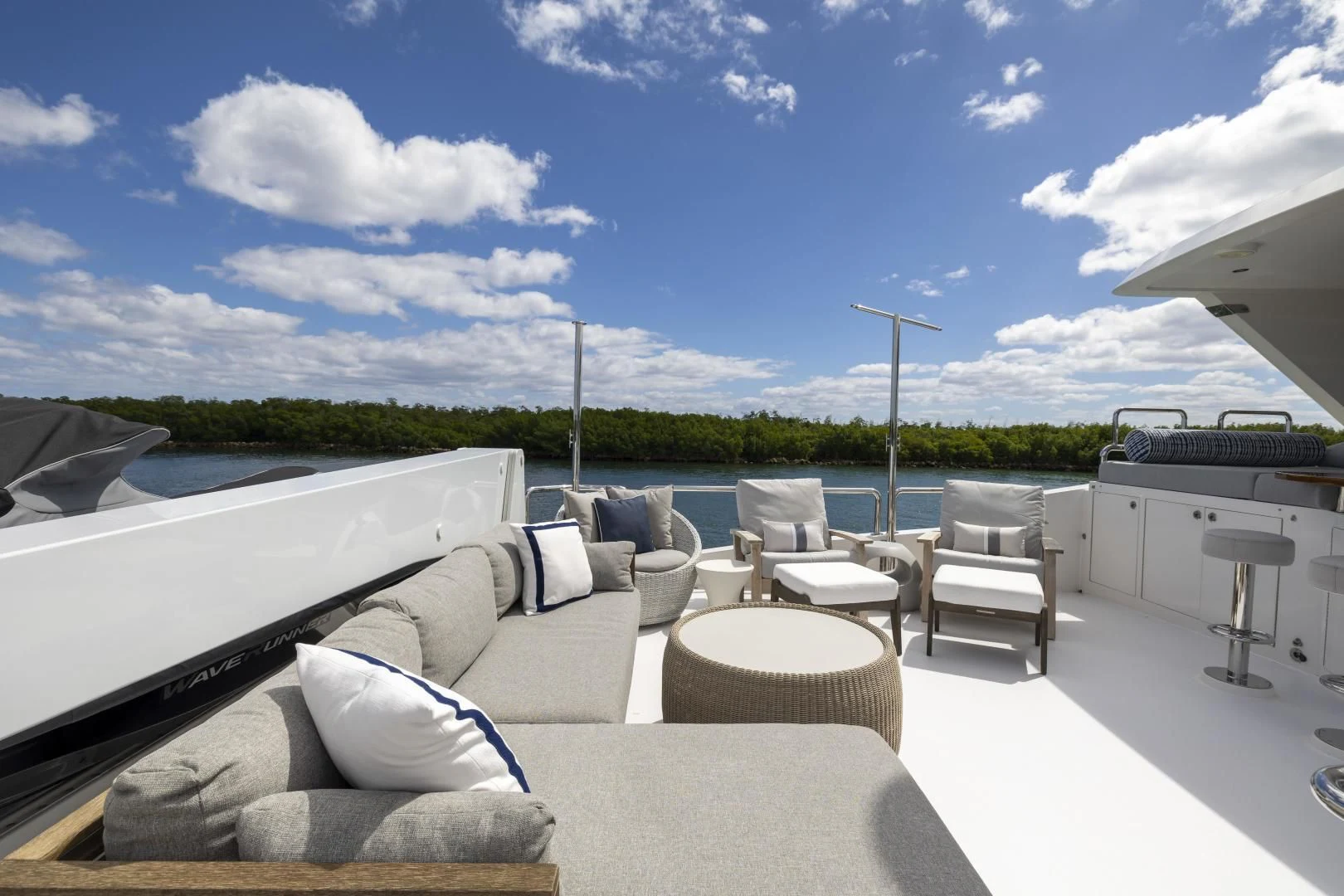 a large white lounge chair next to a large white sofa and a large white table with a white aboard PINGUINITO Yacht for Sale