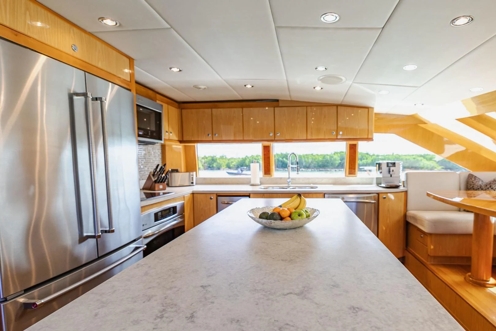 a kitchen with a stainless steel refrigerator aboard PINGUINITO Yacht for Sale