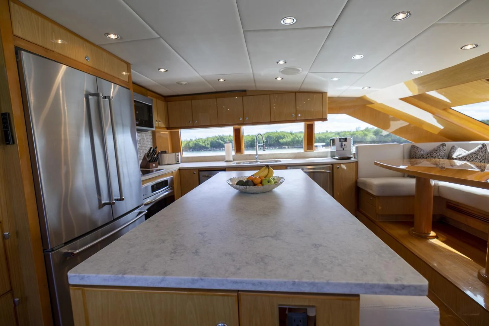 a kitchen with a stainless steel refrigerator aboard PINGUINITO Yacht for Sale