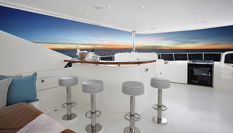 a white yacht with stools aboard PINGUINITO Yacht for Sale