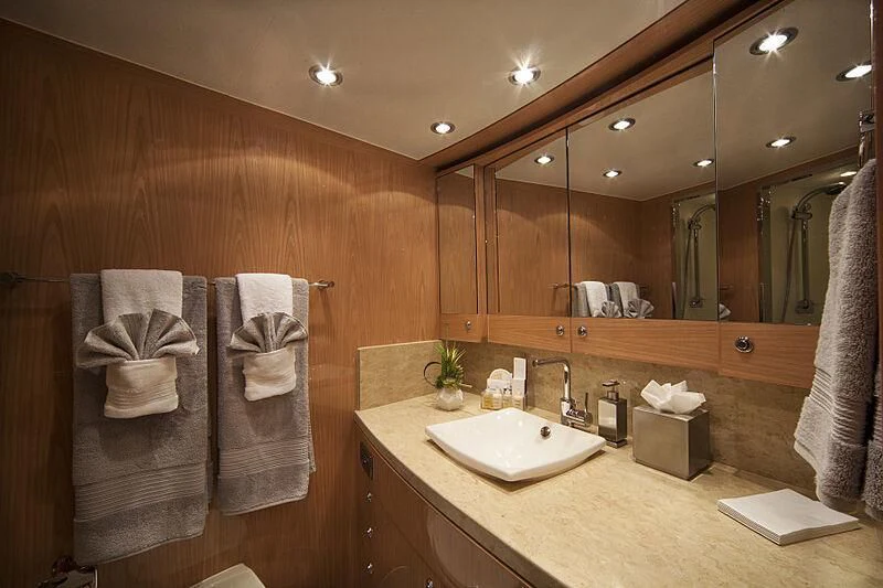a bathroom with a large mirror aboard PINGUINITO Yacht for Sale