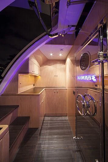 a room with a wood floor and a large mirror aboard PINGUINITO Yacht for Sale