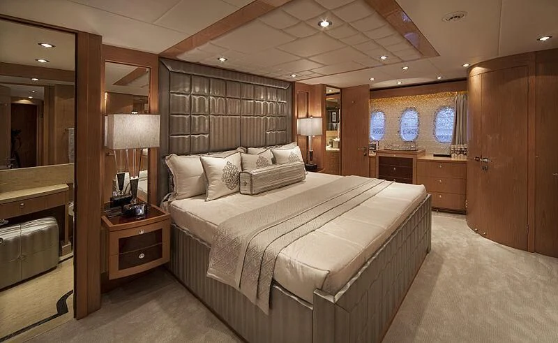a bedroom with a bed and a desk aboard PINGUINITO Yacht for Sale