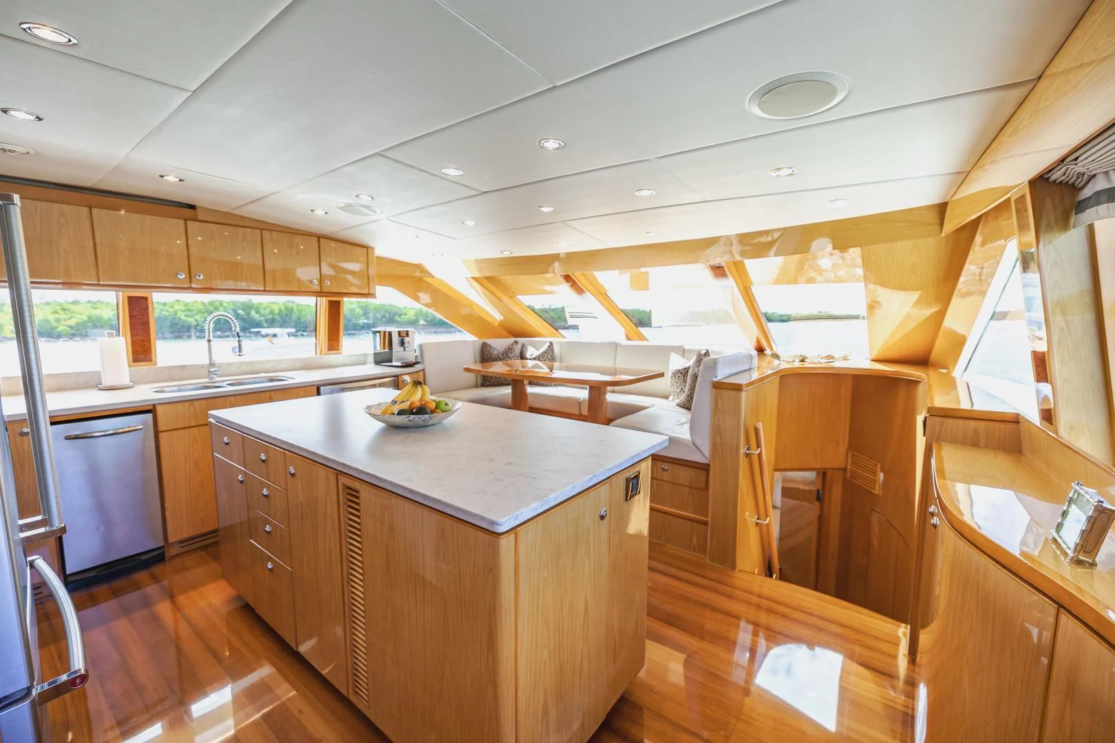 a kitchen with wooden cabinets aboard PINGUINITO Yacht for Sale