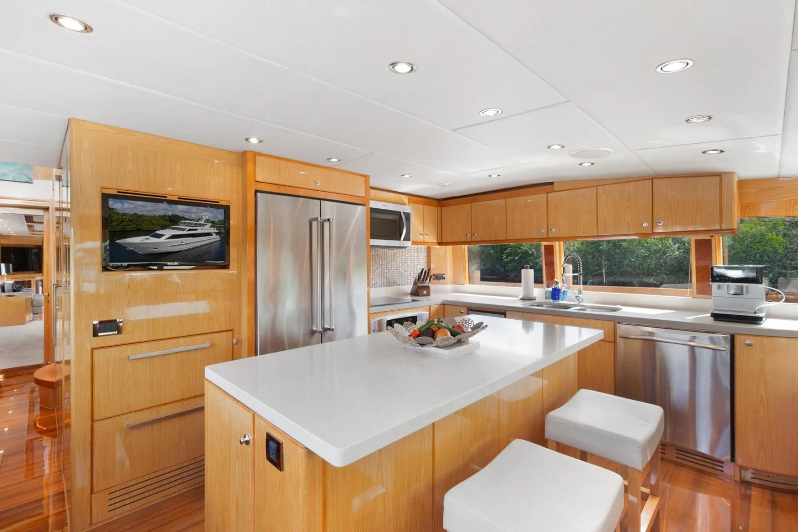 a kitchen with wooden cabinets aboard PINGUINITO Yacht for Sale