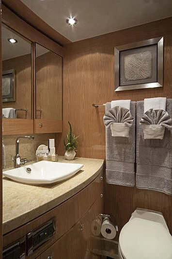 a bathroom with a television and towels aboard PINGUINITO Yacht for Sale