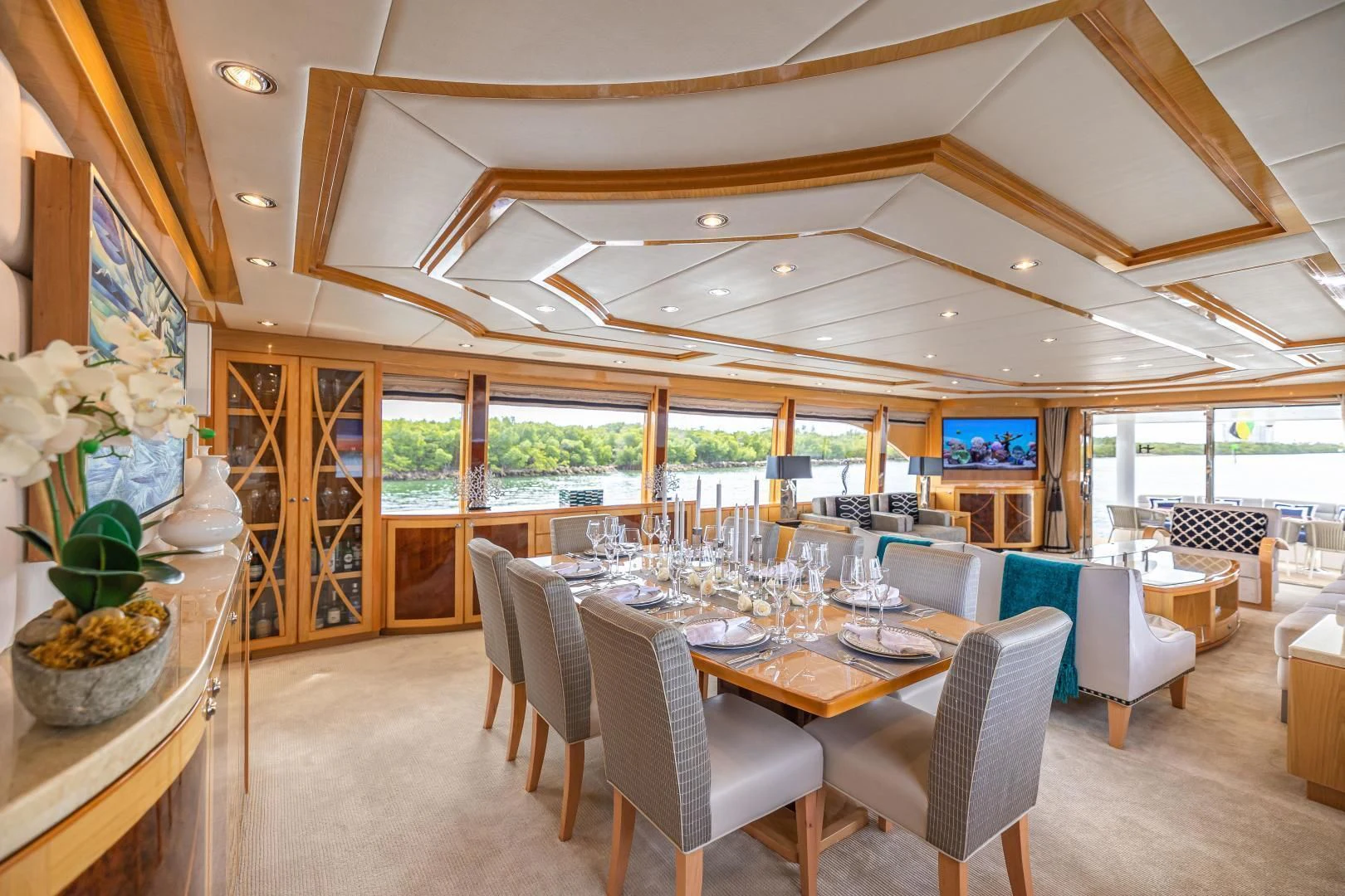 a large dining room with a large table and chairs aboard PINGUINITO Yacht for Sale