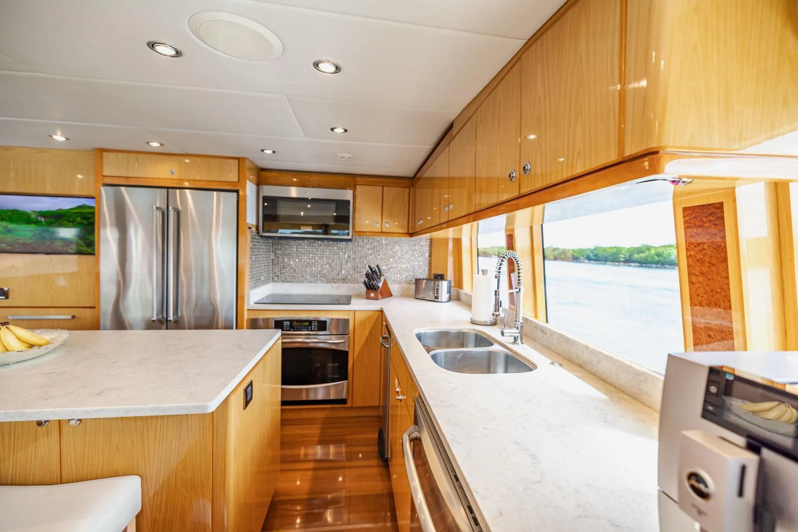 a kitchen with a large window aboard PINGUINITO Yacht for Sale