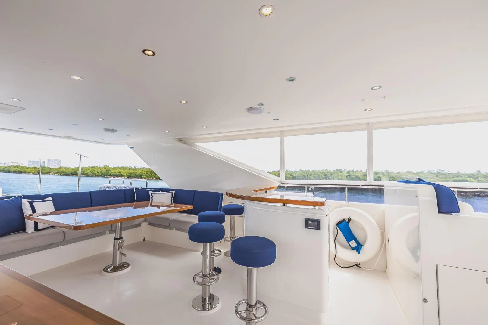 a room with tables and chairs aboard PINGUINITO Yacht for Sale