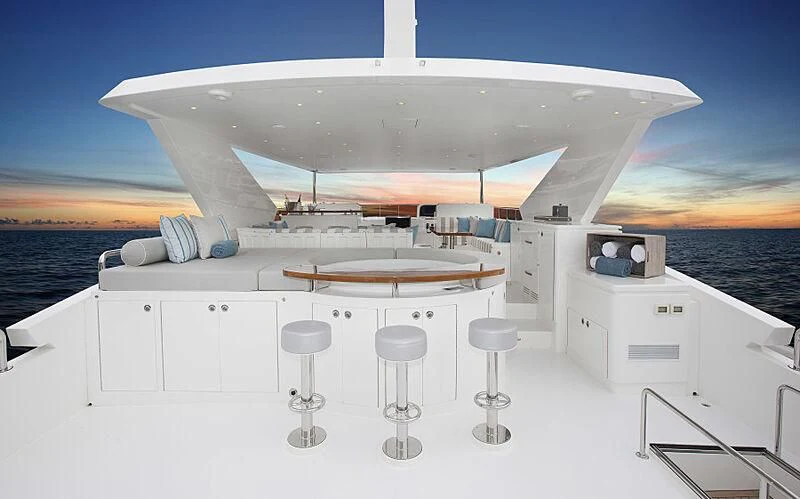 a large white boat with stools on it aboard PINGUINITO Yacht for Sale