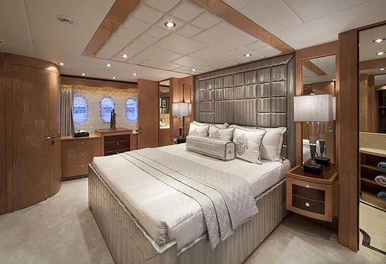 a bedroom with a bed and a mirror aboard PINGUINITO Yacht for Sale