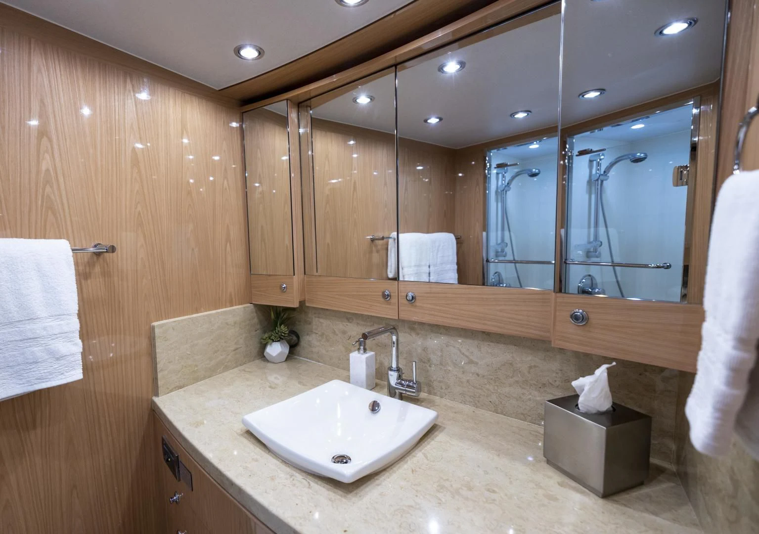 a bathroom with a large mirror aboard PINGUINITO Yacht for Sale