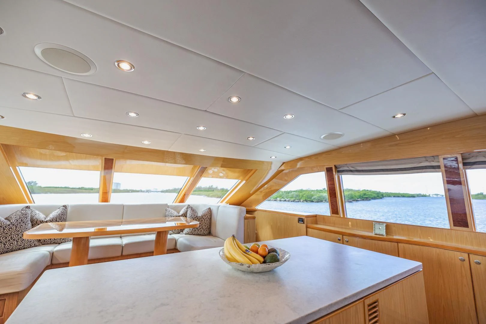 a room with a table and a couch and a large window aboard PINGUINITO Yacht for Sale