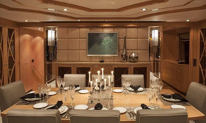 a dining room with a table set aboard PINGUINITO Yacht for Sale