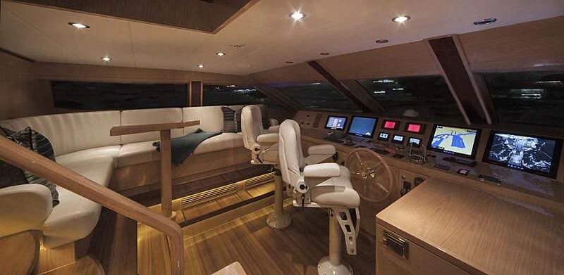 a room with chairs and tables aboard PINGUINITO Yacht for Sale
