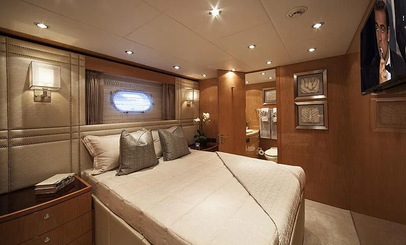 a large bedroom with a large bed aboard PINGUINITO Yacht for Sale