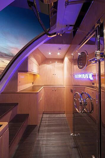 a room with a wood floor and a large window with a view of the sky and clouds aboard PINGUINITO Yacht for Sale