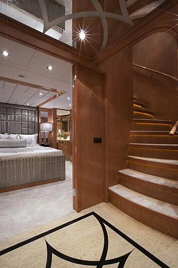 a room with a bed and a large wood door aboard PINGUINITO Yacht for Sale
