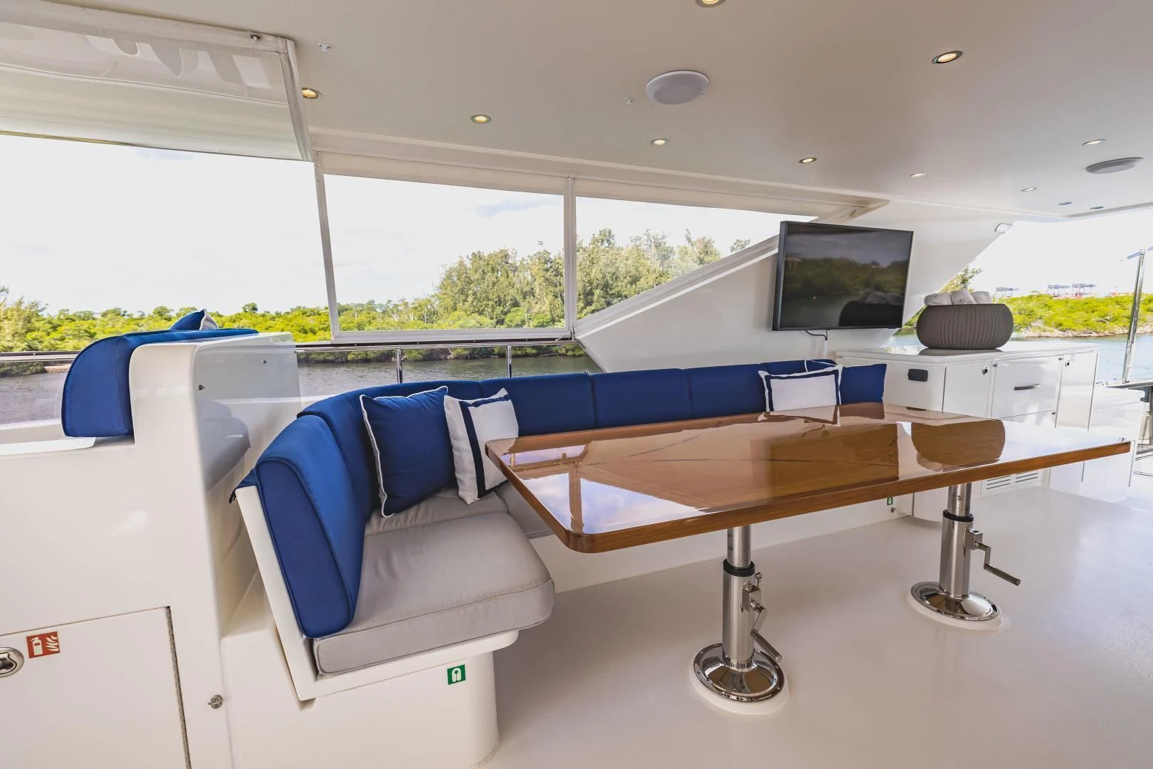 a room with a table and a bed aboard PINGUINITO Yacht for Sale