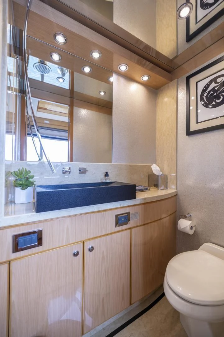 a bathroom with a large mirror aboard PINGUINITO Yacht for Sale