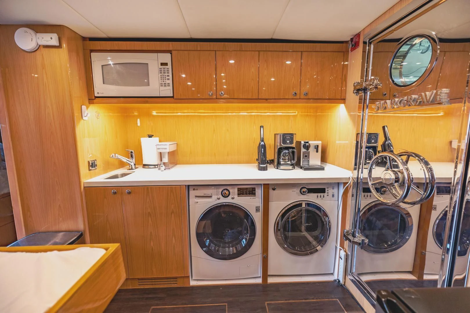 a kitchen with a fan and a microwave aboard PINGUINITO Yacht for Sale
