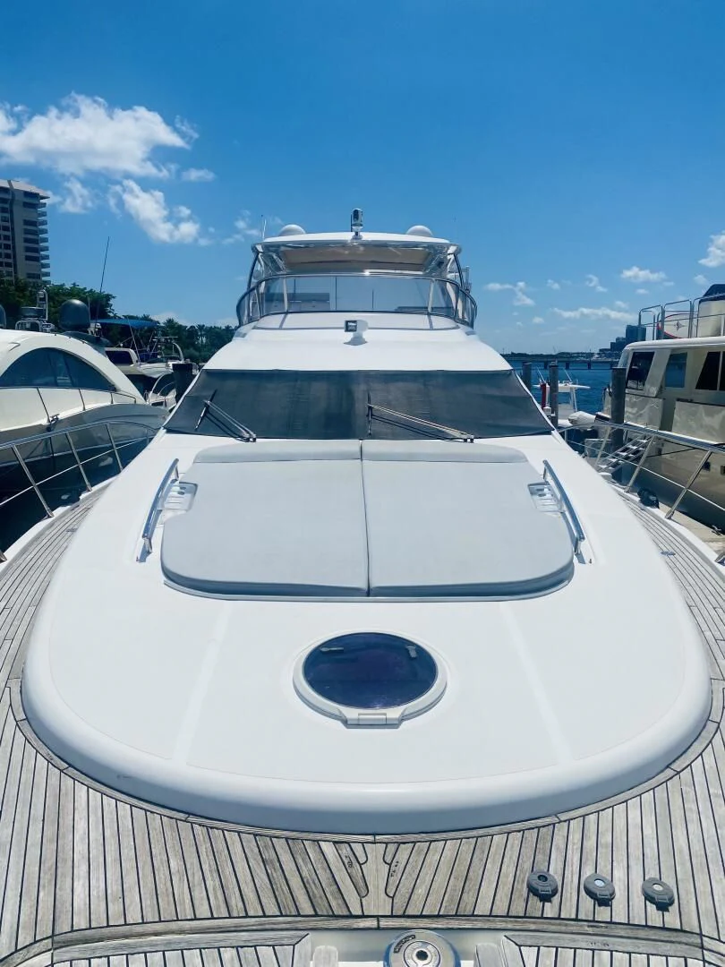 a white yacht in a dock aboard SOMEWHERE I BELONG Yacht for Sale