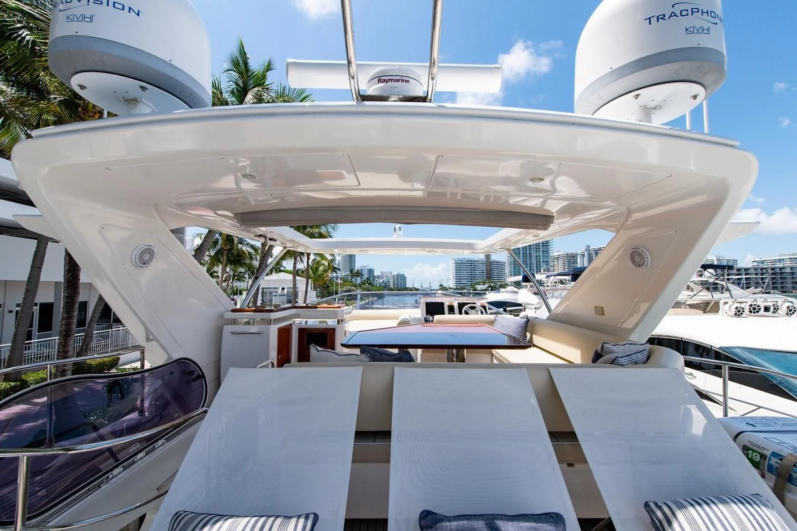 a large white boat with a large ship in the background aboard SOMEWHERE I BELONG Yacht for Sale