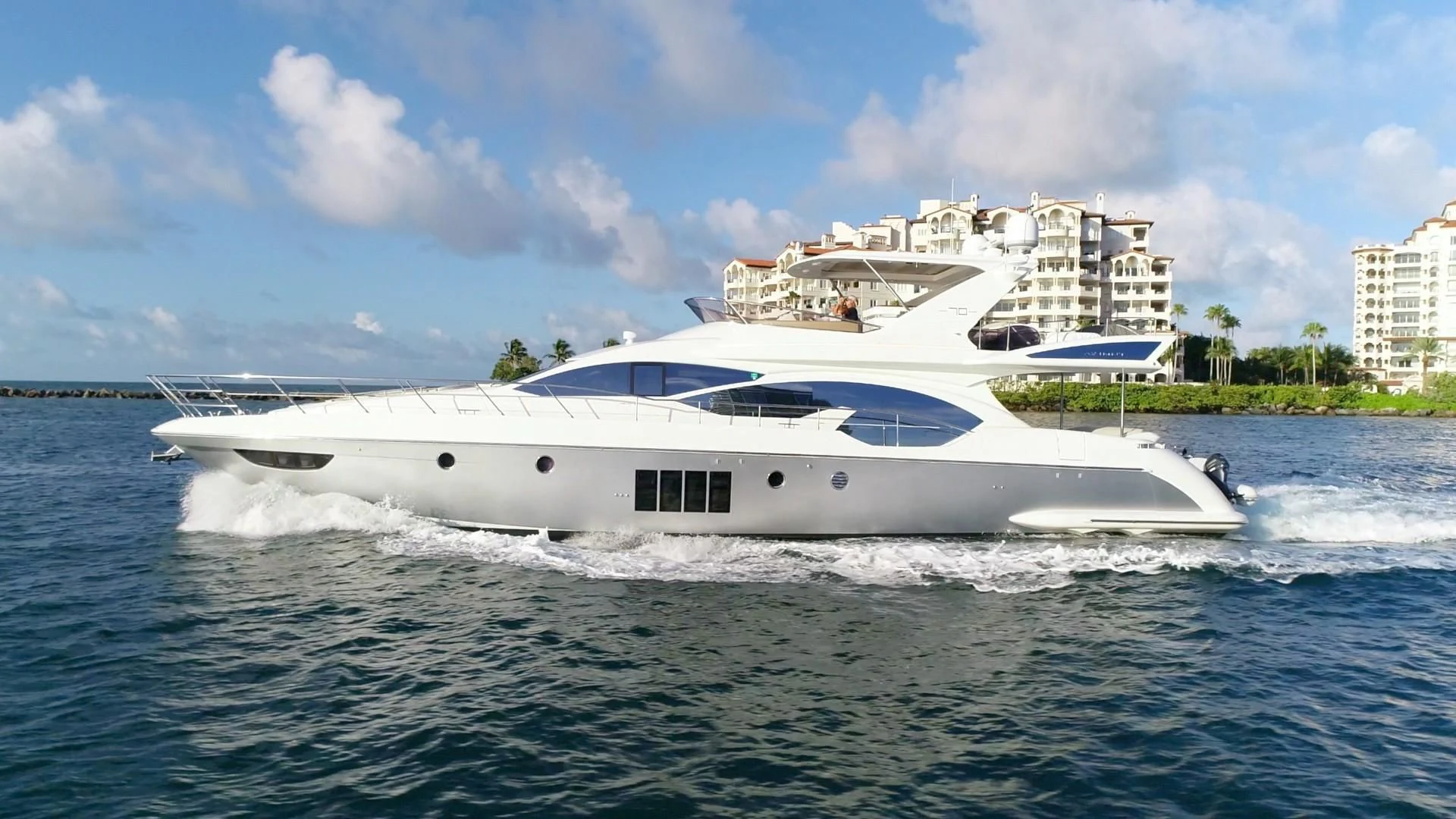 a white yacht on the water aboard SOMEWHERE I BELONG Yacht for Sale