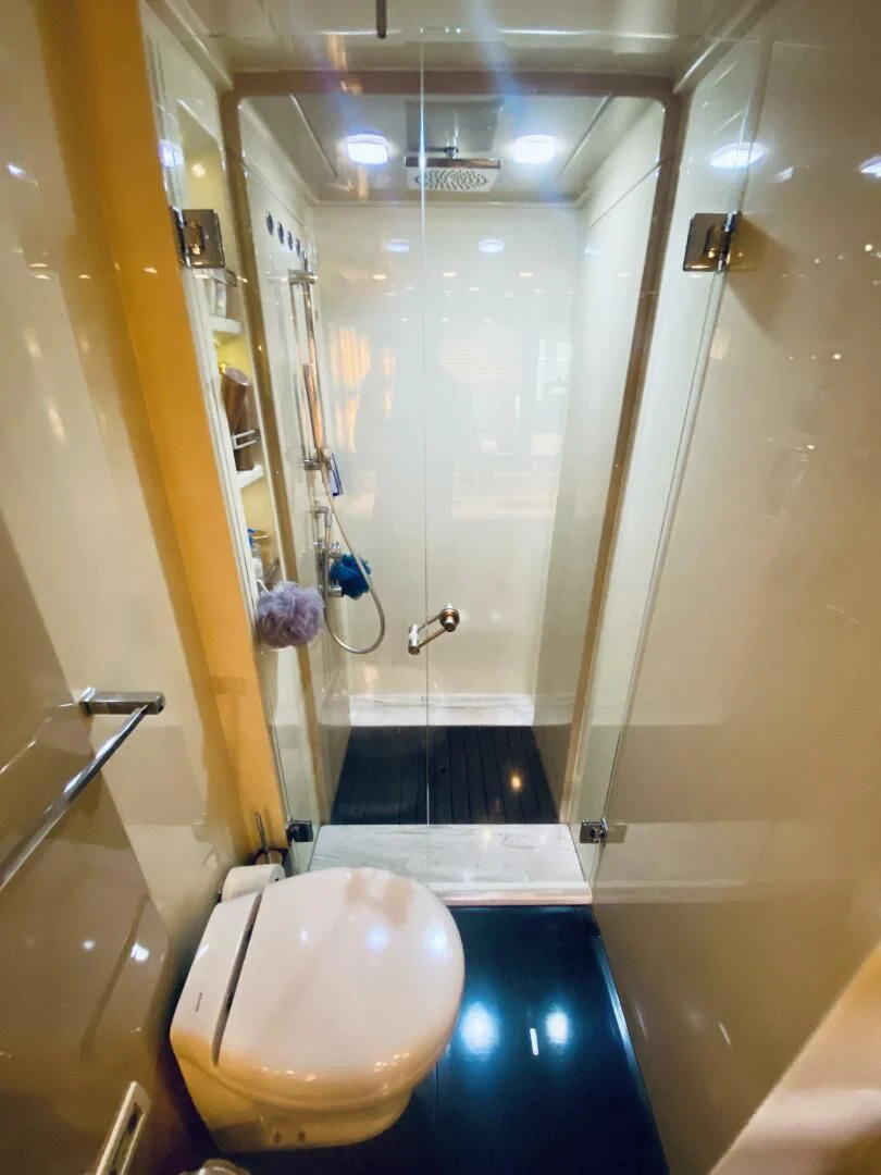 a bathroom with a toilet and shower aboard SOMEWHERE I BELONG Yacht for Sale