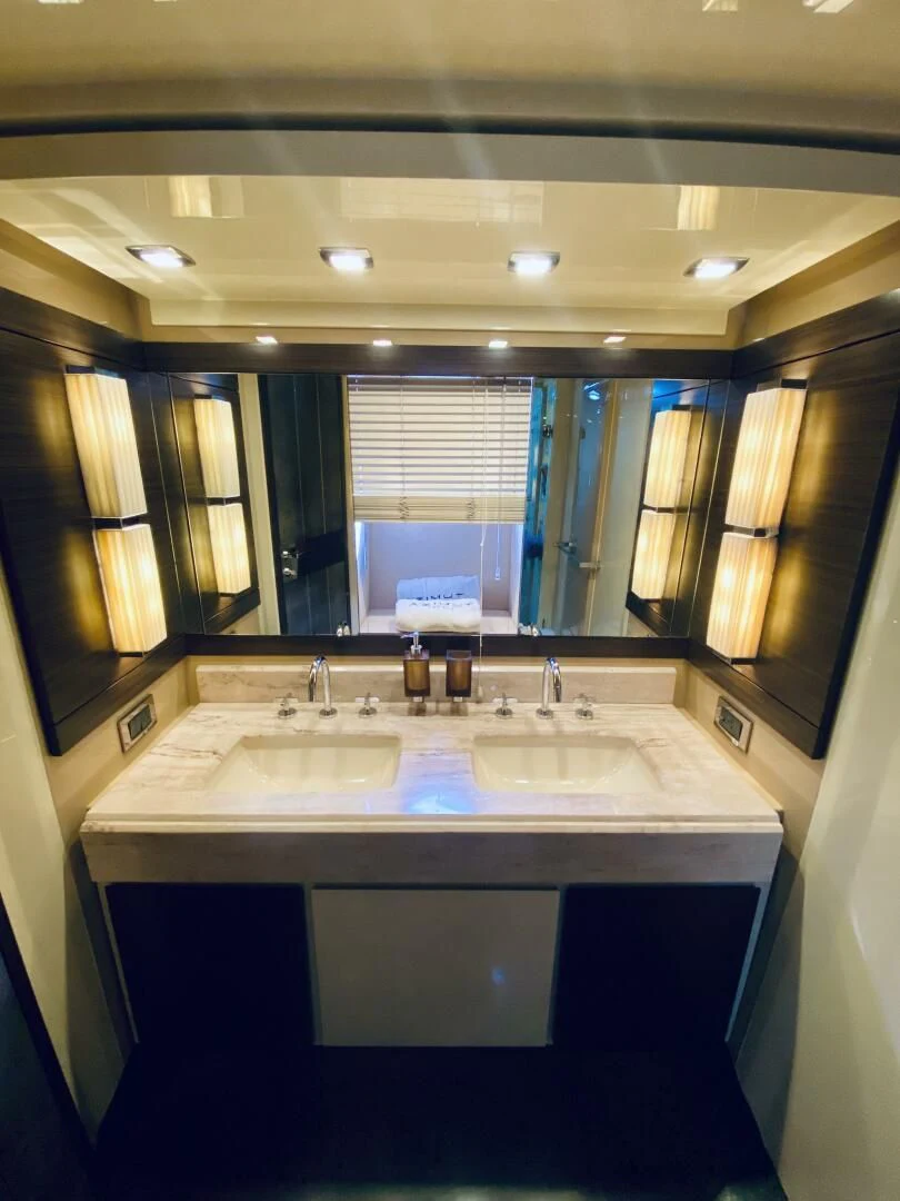 a bathroom with a large mirror aboard SOMEWHERE I BELONG Yacht for Sale