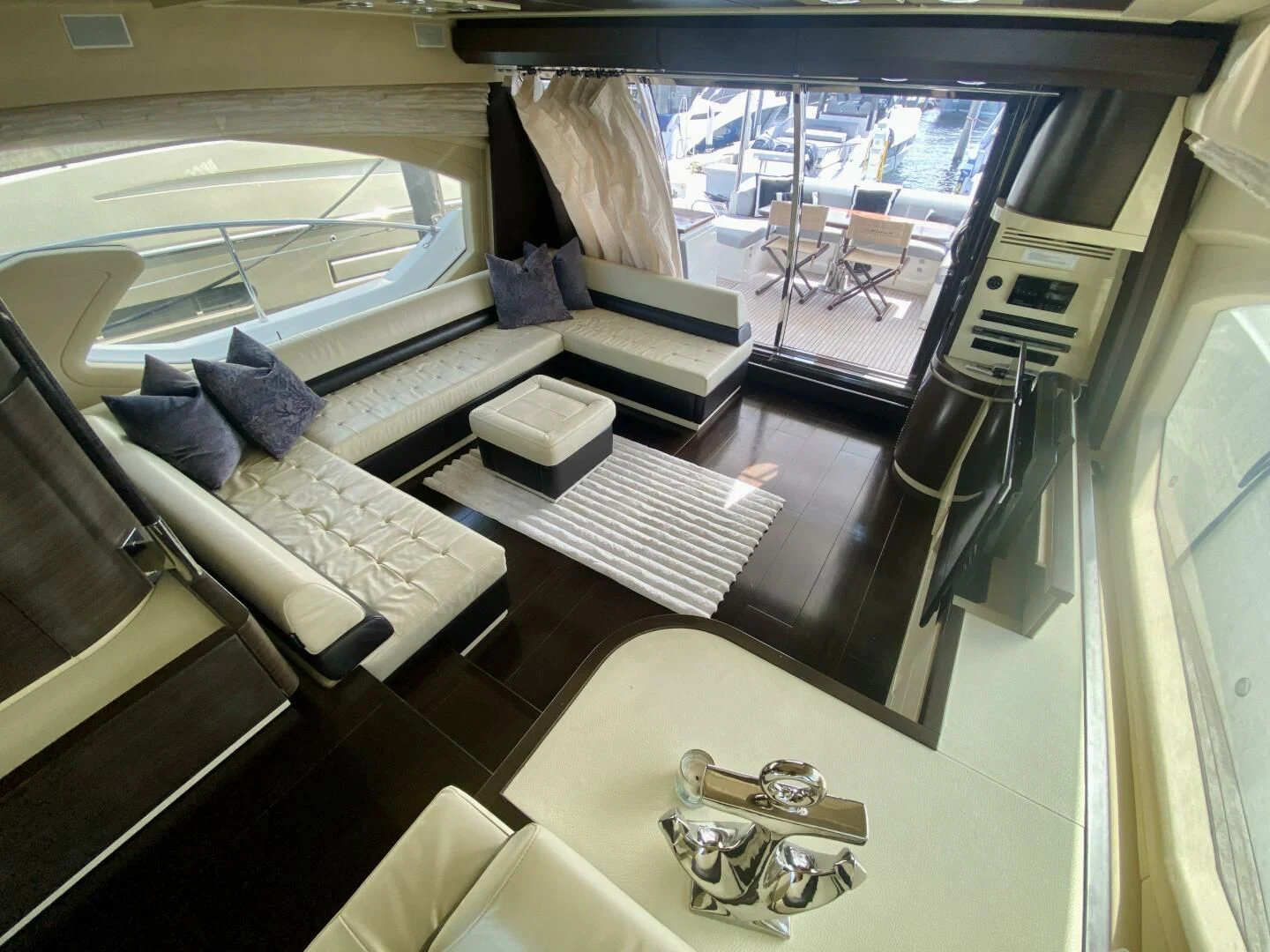a room with a table chairs and a window aboard SOMEWHERE I BELONG Yacht for Sale