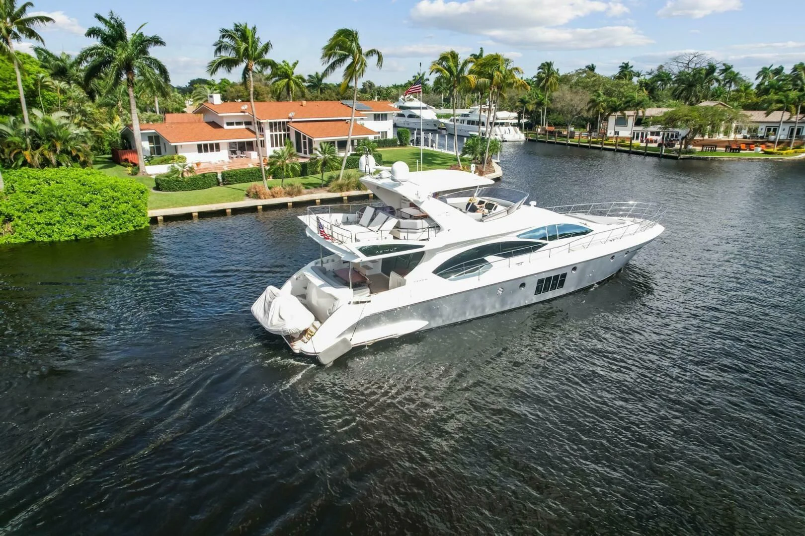 a white boat on the water aboard SOMEWHERE I BELONG Yacht for Sale