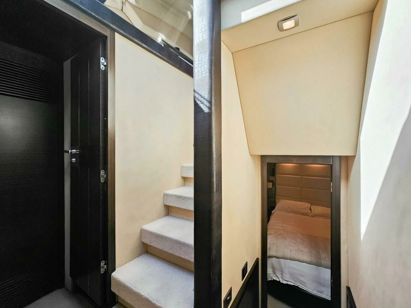 a room with a bed and a door aboard SOMEWHERE I BELONG Yacht for Sale