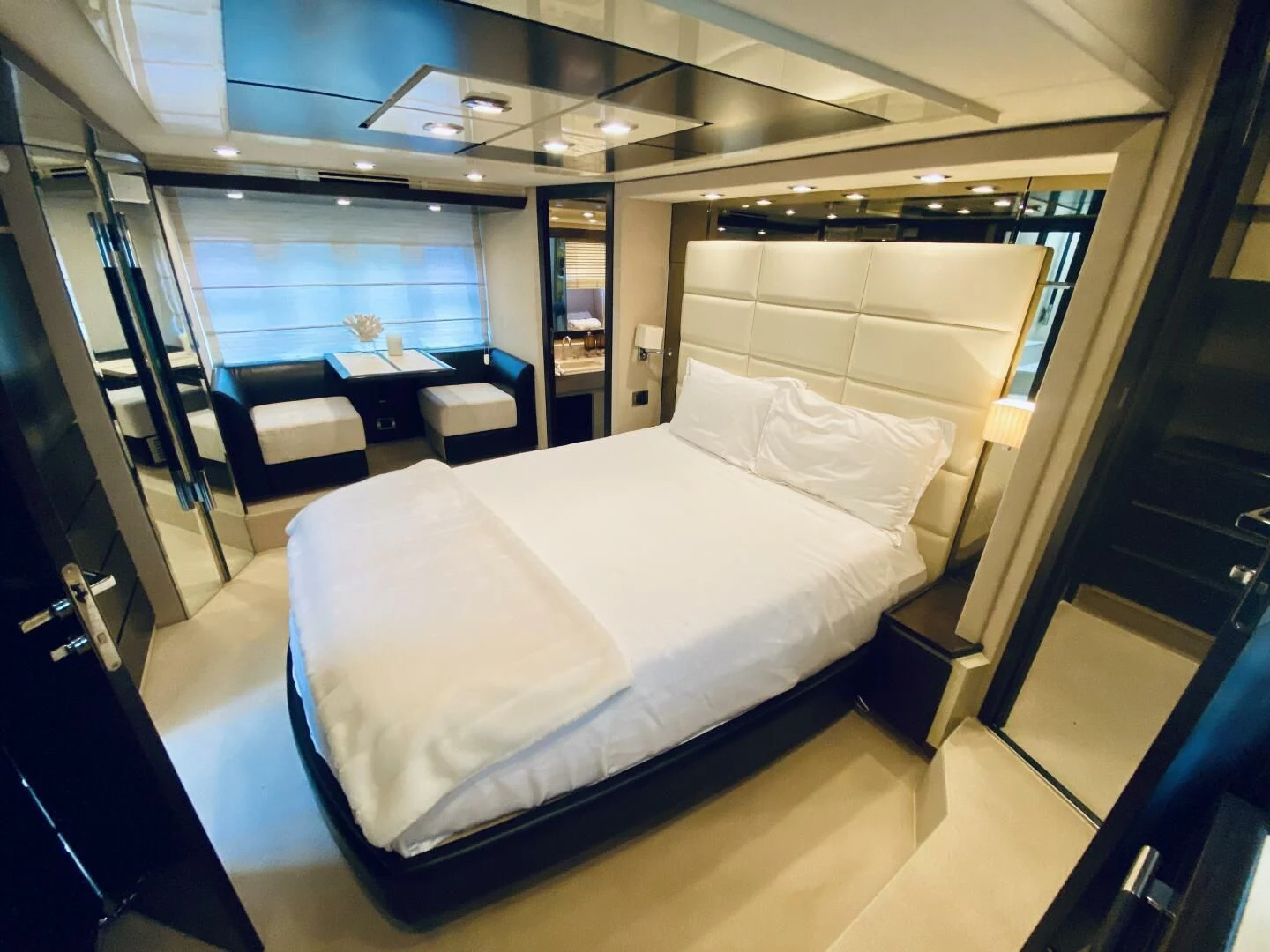 a room with a bed and a table aboard SOMEWHERE I BELONG Yacht for Sale
